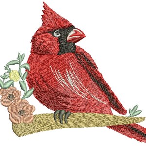 May include: Embroidered image of a vibrant red cardinal bird perched on a tan branch, with a black face and beak. The bird is surrounded by embroidered flowers and leaves in shades of peach, yellow, and green. The design is detailed and textured.