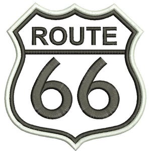 May include: A white and gray shield-shaped sign with the text "ROUTE 66" in black.
