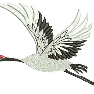 May include: An embroidered design of a crane in flight. The bird has white and black wings, a red crown, and a long, slender beak. The crane is depicted mid-flight, with its wings spread wide.