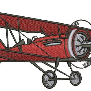 May include: A red vintage biplane with a propeller and landing gear. The plane has a dark gray outline and a white stripe on the propeller.