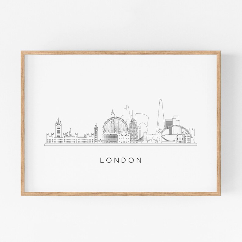 May include: A black and white line art print of the London skyline, featuring iconic landmarks like Big Ben, the London Eye, and the Shard. The print is framed in a light wood frame and has the word "LONDON" printed below the skyline.