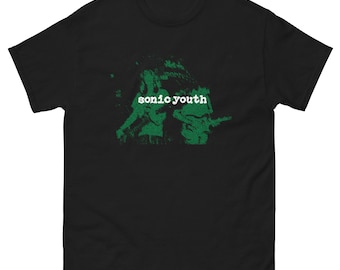 May include: Black t-shirt with a green and white graphic of two people playing guitars. The text "sonic youth" is printed in white on the shirt.