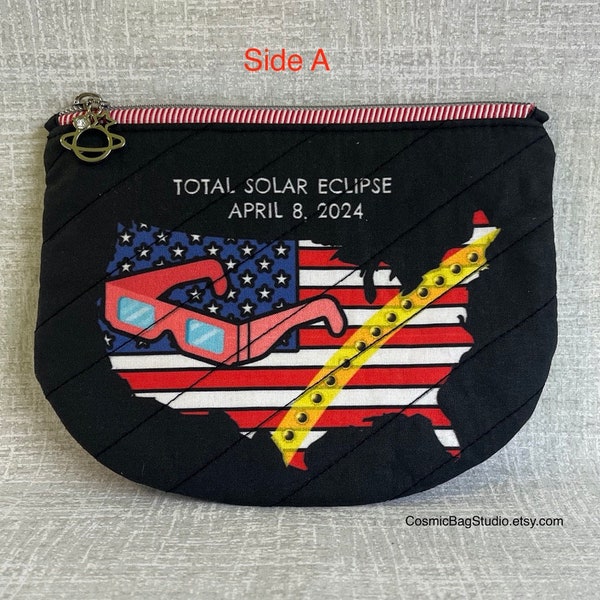 2024 Comemerative Eclipse zipper pouch. Washable. People wearing eclipse glasses peer out from inside.