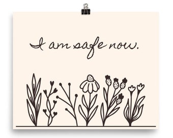 May include: A beige printable poster with black text that reads "I am safe now." and a row of black line drawings of flowers and leaves at the bottom.