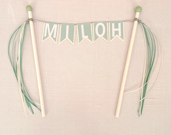 Personalized cake topper bunting-style in sage green, creamy beige and white