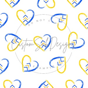 May include: A repeating pattern of blue and yellow hearts on a white background. Each heart is outlined with a brushstroke effect and contains a stylized arrow design. The design is simple and modern.