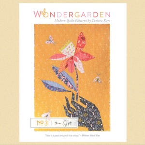 May include: A quilt pattern design featuring a hand holding a stylised flower with a yellow background. The pattern is titled "The Gist" and is part of the "Wondergarden" collection of quilt patterns by Tamara Kate.