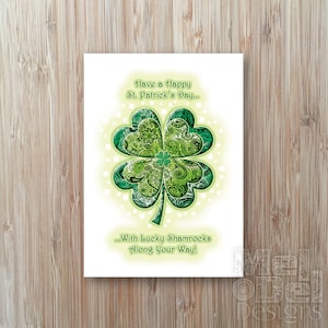 May include: A white card with a green shamrock design and the text "Have a Happy St. Patrick's Day... With Lucky Shamrocks Along Your Way!"