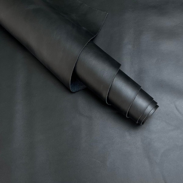 Black soft leather cowhide. Leather for crafting, shoesmaking, upholsery, earings, wallets. Leather rolls