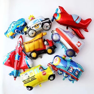May include: A set of nine foil balloons featuring different vehicles, including a police car, a school bus, a dump truck, an ambulance, a train, and two airplanes. The balloons are all in bright colors and have a shiny finish.