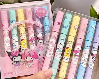 May include: A set of six colorful markers featuring Sanrio characters. The markers are in a clear plastic case with a pink and white background. The text on the case reads "Sanrio Characters" and "Fluorescent 6PCS".