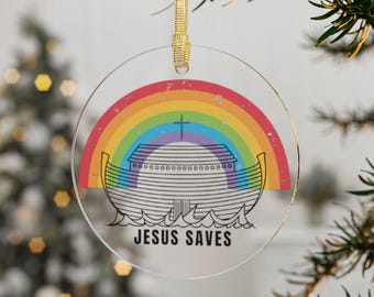 May include: A round, clear glass ornament with a rainbow and a white ark with the text "JESUS SAVES" on a white background.