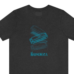 May include: A dark heather grey t-shirt with a blue outline drawing of a harmonica. The text "HARMONICA" is printed in blue below the harmonica.