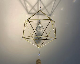 Stainless steel icosahedron, brass icosahedron, sacred geometry, platonic solids, meditation, kinetic art, interior design.