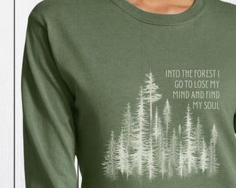 May include: A green long-sleeve shirt with a white graphic of trees and the text "Into the forest I go to lose my mind and find my soul."