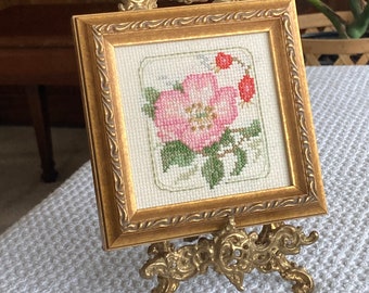 Framed cross-stitch flower embroidery