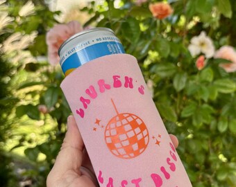 May include: Pink can cooler with the text "Lauren's Last Disco Mystic, CT 2024" and a pink and orange disco ball graphic.