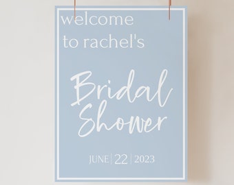 以下が含まれることがあります： 「welcome to rachel's bridal shower JUNE 22 2023」と書かれた薄い青色の看板。