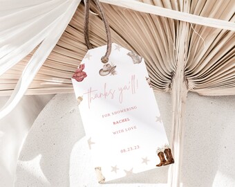 May include: White gift tag with pink and brown illustrations of cowboy boots, hats, and stars. The text on the tag reads "Thanks ya'll!"  "For showering Rachel with love" and "08.23.23".