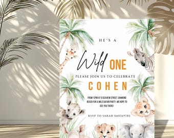 May include: A white invitation with a safari theme. The text reads "He's a Wild One" and invites guests to celebrate Cohen. Features watercolor illustrations of a giraffe, zebra, lion, rhino, and elephant. Includes RSVP details.