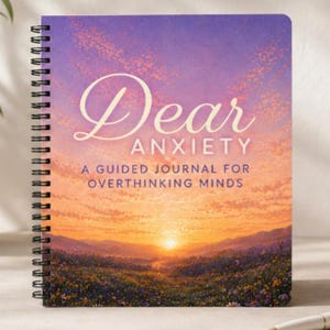 May include: A spiral-bound journal titled "Dear Anxiety" with a sunset landscape design. The cover features the text "Dear Anxiety" in elegant script, with the subtitle "A Guided Journal for Overthinking Minds".