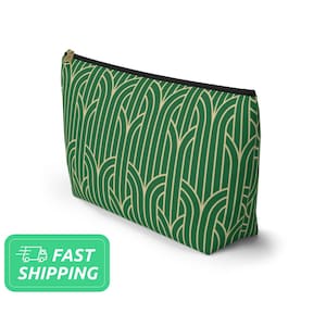 May include: Green and gold geometric patterned makeup bag with a black zipper.