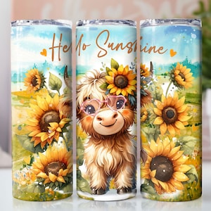 May include: A stainless steel tumbler with a colorful design featuring a cartoon Highland cow with pink glasses and sunflowers. The tumbler has the text "Hello Sunshine" on it.