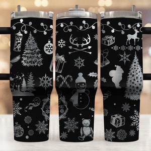 May include: A black stainless steel tumbler with a white design featuring Christmas-themed illustrations, including a snowman, reindeer, a Christmas tree, and snowflakes. The tumbler has a handle and a lid.