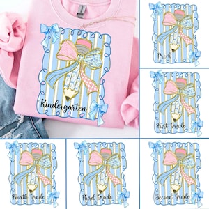 May include: A light pink sweatshirt featuring a pencil design with a pink and blue bow, blue ribbons, and the word "Kindergarten" in a blue frame. Additional images show similar designs for Pre-K, 1st, 2nd, 3rd, and 4th grade.