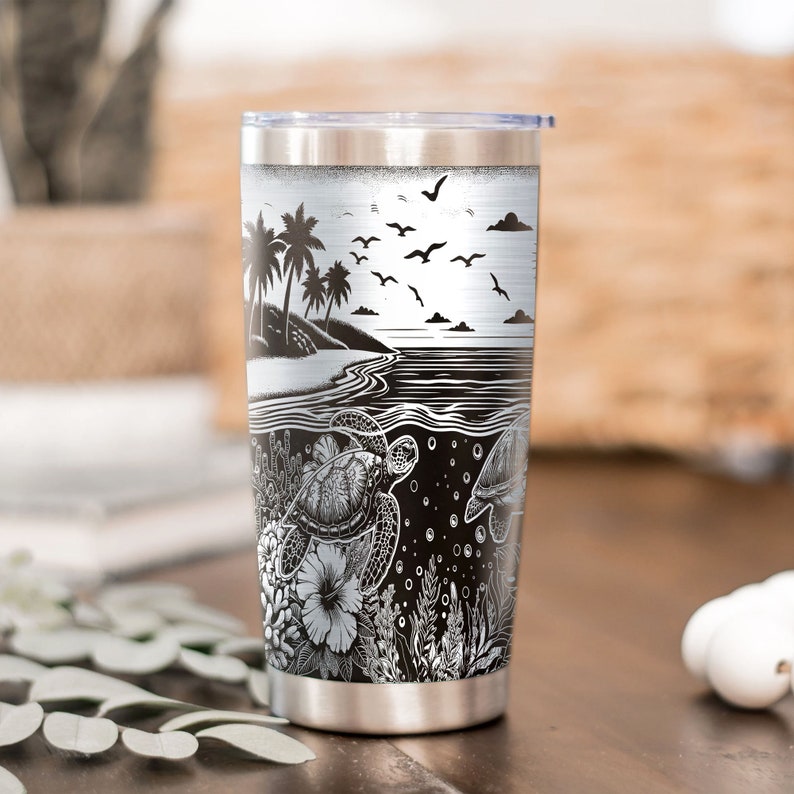 May include: A stainless steel tumbler with a black and white design featuring palm trees, seagulls, ocean waves, and sea turtles. The design is reminiscent of a tropical beach scene.
