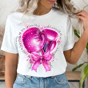 May include: White t-shirt with a pink boxing glove design and the text "Together we fight + Together we win... Together we fight + Together we win".