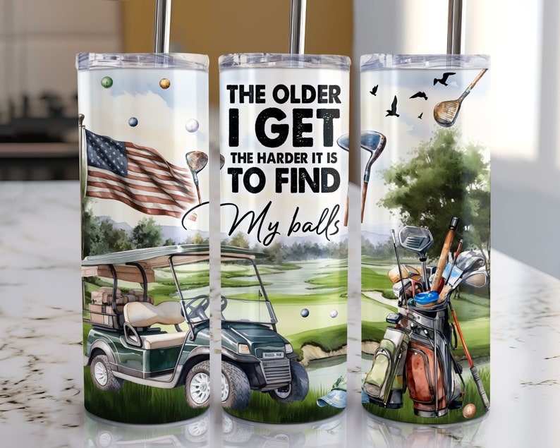 May include: A set of three stainless steel tumblers with a golf theme. The tumblers feature a green golf course, a golf cart, golf clubs, and the text "The older I get the harder it is to find my balls".