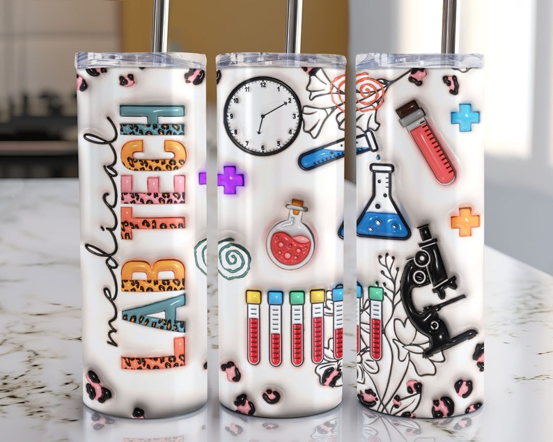 May include: Three white stainless steel tumblers with lids and straws. The tumblers are decorated with a variety of colorful science-themed images, including test tubes, beakers, a microscope, and a clock. The text "Lab Tech" is written on one of the tumblers.