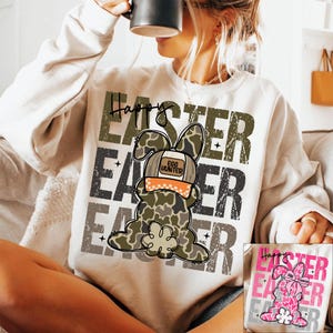 May include: A white sweatshirt with a camouflage bunny wearing a hat that says "Egg Hunter" and the text "Happy Easter" repeated multiple times in a distressed font.