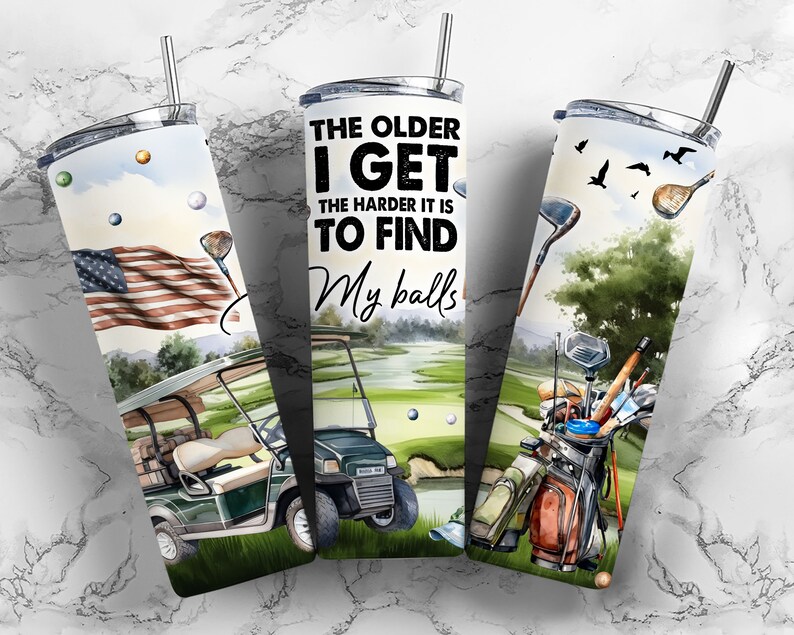 May include: A set of three stainless steel tumblers with a golf theme. The tumblers feature a watercolor design of a golf course, golf clubs, and a golf cart. The text on the tumbler reads "The older I get the harder it is to find my balls".