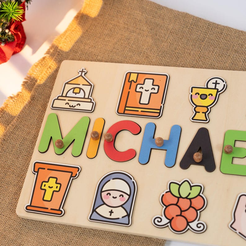 May include: A wooden personalized puzzle with the name "MICHAEL" in colorful letters. The puzzle features religious icons like a church, a bible, a chalice, a nun, and grapes.