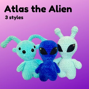 May include: Three crocheted alien plush toys. One is blue, one is light blue, and one is light blue with a darker blue face. The toys are all standing on a purple background. The text "Atlas the Alien" and "3 styles" is above the toys.