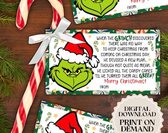 May include: A printable Christmas card featuring the Grinch with a red Santa hat. The card has a green, red, and white background with a festive design. The text on the card reads: "When the Grinch discovered there was no way to keep Christmas from coming on Christmas Day. He devised a new plan... though not quite as mean. He licked all the candy canes 'til he turned them all GREEN! Merry Christmas!"