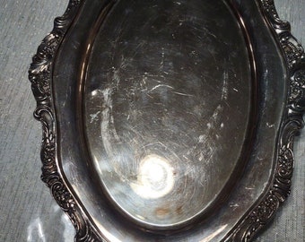 May include: A silver oval serving tray with an ornate, raised, decorative border.