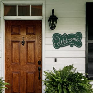 May include: A white ceramic mug with a black handle and the text "But First, Coffee" in a bold, black font. The mug is sitting on a wooden surface. The mug is approximately 4 inches tall.