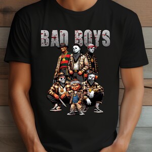 Man wearing a black Halloween t-shirt featuring the Bad Boys of Horror PNG design with Freddy Krueger, Michael Myers, Pinhead, Jason Voorhees, Pennywise, and Chucky. The characters are dressed in brown plaid streetwear with bandanas, sneakers, and gold chains, standing under bold gray blood-splattered text that reads ‘Bad Boys.’ Horror PNG artwork displayed on apparel.
