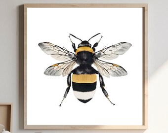 May include: A framed watercolor print of a bumblebee. The bee is depicted with black and yellow stripes, transparent wings, and detailed legs and antennae. The artwork is displayed on a white background within a light wood frame, suitable for home decor.