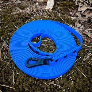 Waterproof Custom Long Leash for Dogs – Designed for active pet owners, this adjustable tracking leash is built with Hexa water-resistant webbing for unbeatable durability. Perfect for training, tracking, or long walks, this dog leash remains strong and reliable in any condition. Its waterproof design and adjustable features ensure a custom fit and ease of use, making it an essential piece of pet gear for outdoor adventures.