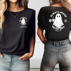 May include: Black t-shirt with a white graphic of a ghost holding a coffee cup. The text "Always Heard Never Seen Dispatch" is printed around the ghost. The text "Jennifer #14" is printed below the graphic.