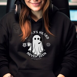 May include: Black hooded sweatshirt with a white ghost graphic and the text "Always Heard Never Seen Dispatch".