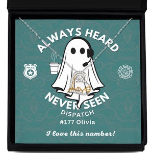 May include: A silver and gold necklace with a heart pendant that says "Love" in cursive. The necklace is in a black box with a teal background and the text "Always Heard Never Seen Dispatch #177 Olivia I love this number!"