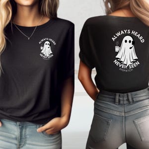May include: Black t-shirt with a white ghost graphic and the text "Always Heard Never Seen Dispatch".