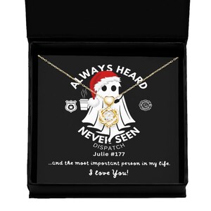 May include: A black box with a white card inside. The card features a cartoon ghost wearing a Santa hat and holding a coffee cup. The text on the card reads "Always Heard Never Seen Dispatch Julie #177...and the most important person in my life. I love You!"