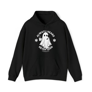 May include: Black hoodie with a white graphic of a ghost holding a cup of coffee. The text on the graphic reads "Always Heard Never Seen Dispatch."