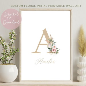 May include: Printable wall art featuring a floral design with a large letter A in beige and the name Amelia written below. The floral design includes pink roses, green leaves, and beige dried grasses.